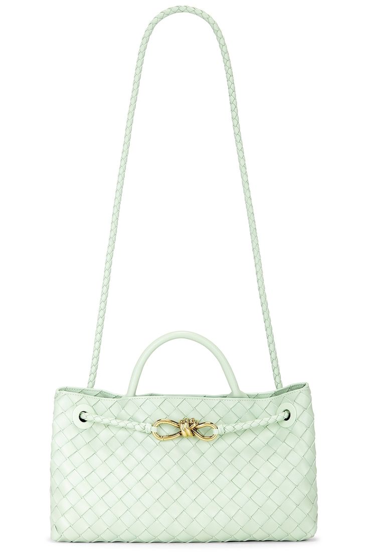 Find BOTTEGA VENETA Small East West Andiamo Bag In Mint on Editorialist. Bottega Veneta Small East West Andiamo Bag in Mint Intrecciato leather. Made in Italy. Top magnetic button closure. Two compartments. 3 interior slip pockets. Interior zipper compartment. Structured top handle with braided leather shoulder strap with gold-tone knotted hardware. Measures approx 11.4 W x 7.1 H x 3.9 D Shoulder strap with a 21.9 drop Top handle with a 3.1 drop. BOTT-WY1652. 766010-VCPP1-1877. About the designer: Bottega Veneta – inspiring individuality with innovative craftmanship since 1966. Creativity lies at the heart of all that we do. Born in Vicenza the house is rooted in Italian culture yet maintains a truly global outlook. An inclusive brand with exclusive products Bottega Veneta is as much of a Andiamo Bag, Mint Bag, Structured Top, Structured Bag, Drop Top, Medium Tote, Fresh Mint, East West, Braided Leather