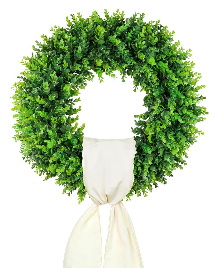 a white scarf tied around a green wreath