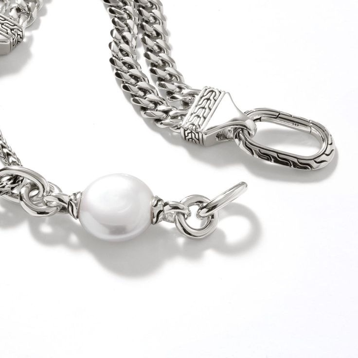 Unique, elegant, and modern, this John Hardy chain collection cultured freshwater pearl bracelet is the perfect way to bring together modern design and timeless style! The John Hardy Chain Collection is a refreshing alternative to classic sterling silver jewelry. Modern, intriguing, and creative, Chain Collection pieces bring character and personality to any outfit they accessorize. Established in Bali in 1975, John Hardy is dedicated to the creation of ultimate beauty through artisan handcrafte Freshwater Pearl Bracelet, John Hardy, Pearl Pendant Necklace, Pearl Chain, Curb Chain, Pearl Pendant, Chain Link Bracelet, Pearl Bracelet, Timeless Style