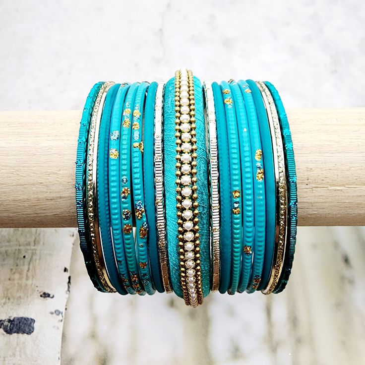 Beautifully designed bangles for any occasion. South asian bracelets come in a variety of styles, colors, and finishes. We at Banglez take creating the perfect bangle set for you to another level! You could say helping you find your favorite stack of bangles as one of our greatest missions. This bangle set was curated in house by one of our talented team members. We hope you love them as much as we do! Bohemian Stackable Wedding Bracelets, Traditional Stackable Bangle Bracelets, Stackable Festival Bangles, Stackable Bangle Bracelets For Festivals, Stackable Bracelets For Festivals, Festive Stackable Bracelets For Festivals, Festive Green Stackable Bracelets, Gold Bangle Wrap Bracelet For Festival, Turquoise Bangle Bracelets For Wedding