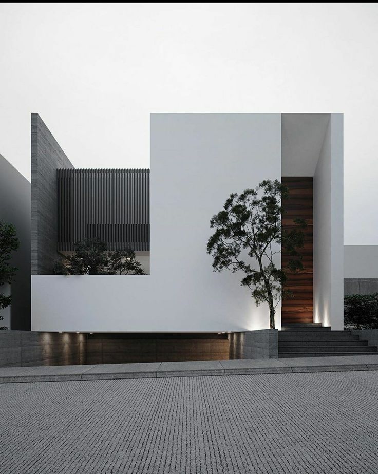 a white building with two trees in front of it