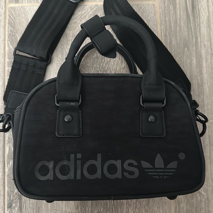 Removable Strap Black On-the-go Bag With Detachable Strap, On-the-go Black Bag With Detachable Strap, Functional Adidas Bags For On-the-go, Casual Black Bag With Detachable Handle, Functional Black Bags With Adjustable Handle, Functional Black Bag With Adjustable Handle, Black Satchel With Adjustable Handle For Daily Use, Black Satchel With Adjustable Handle For Shopping, Versatile Black Shoulder Bag With Top Carry Handle