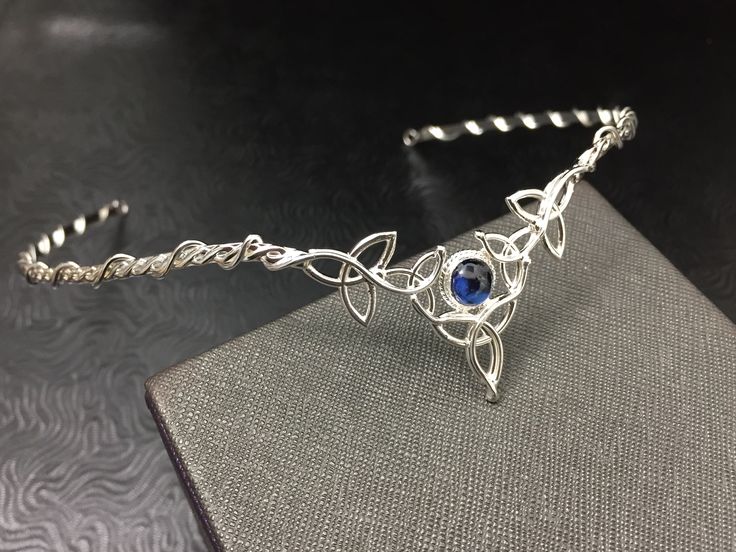 I've fabricated a Celtic Irish wedding bridal circlet, in sterling silver, featuring 5 Trinity Knots with an 8mm round cabochon Of your choice in the drop down menu. This Celtic tiara is lovely, slightly Bohemian and sophisticatedly elegant. This wedding circlet can be used for a wedding accessory, or any costuming event, such as cosplay or a Renaissance fair! Please allow me 5 business days to fabricate a new headpiece for you! **For matching earrings: https://www.etsy.com/listing/42139307/ster Traditional Hand Forged Wedding Jewelry, Traditional Hand Forged Jewelry For Wedding, Adjustable Silver Jewelry With Halo Detail, Adjustable Hand Set Silver Necklaces, Adjustable Hand Set Silver Necklace, Elegant Adjustable Jewelry For Ceremonies, Adjustable Crown Jewelry For Formal Occasions, Silver Hand Forged Jewelry For Wedding, Handmade Silver Crown-shaped Jewelry