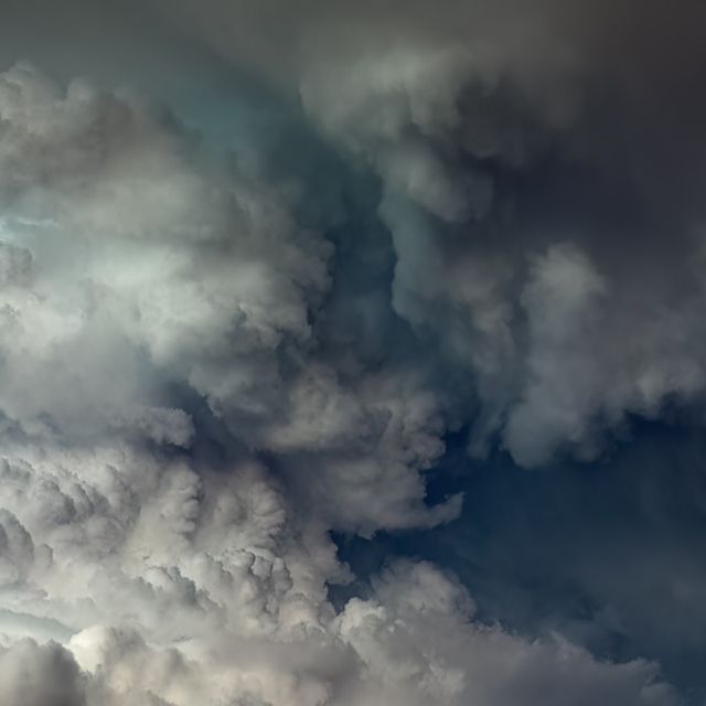 an airplane is flying in the cloudy sky