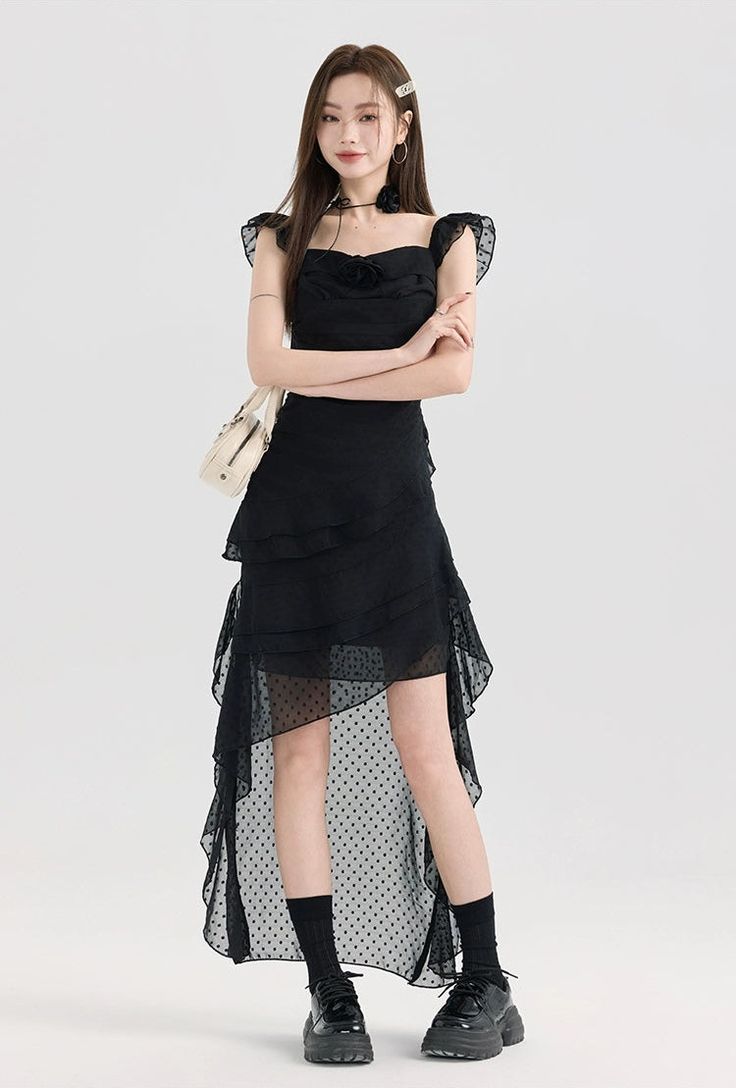 Embrace your edgy side with this Tiered Ruffle Midi Dress with Floral Detail that masterfully balances nonchalance with a touch of sophistication. Crafted for modern aesthetics, this midi dress features delicate ruffles that cascade down for an eye-catching effect. The square neckline and sleeveless design add a contemporary touch, while the A-line silhouette and high waist offer a flattering fit. The dress's solid color serves as a canvas for personal expression, crafted from a lightweight fabr Feminine Ruffled Midi Dress, Feminine Midi Dress With Ruffled Skirt, Ruffled Midi Dress For Prom, Spring Midi Dress With Ruffle Hem For Night Out, Cocktail Midi Dress With Ruffle Hem, Asymmetrical Midi Dress For Prom, Prom Dresses With Ruffled Midi-length Skirt, Flirty Tiered Skirt Evening Dress, Prom Dresses With Ruffled Midi Skirt