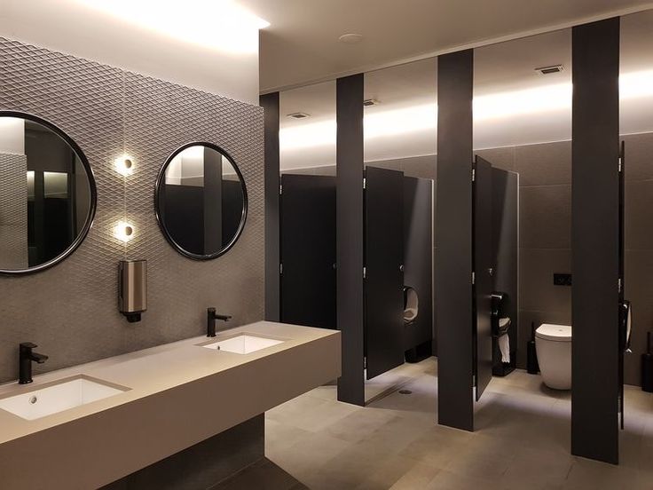 a bathroom with three sinks, mirrors and urinals