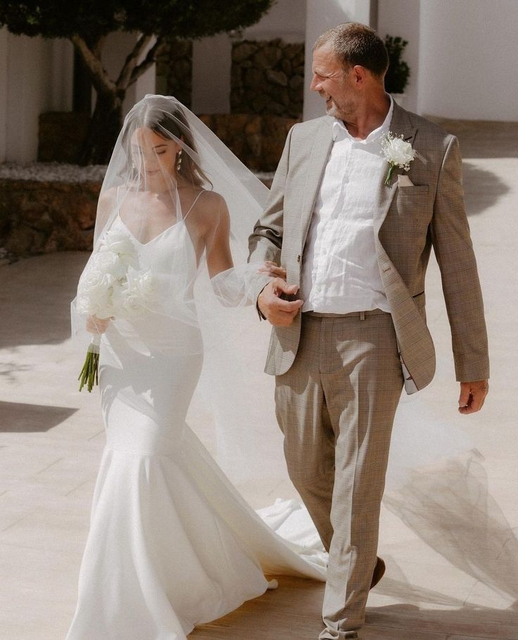 a bride and groom walking down the aisle