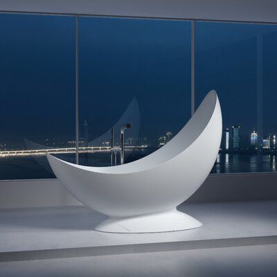 a large white sculpture sitting in front of a window next to a body of water