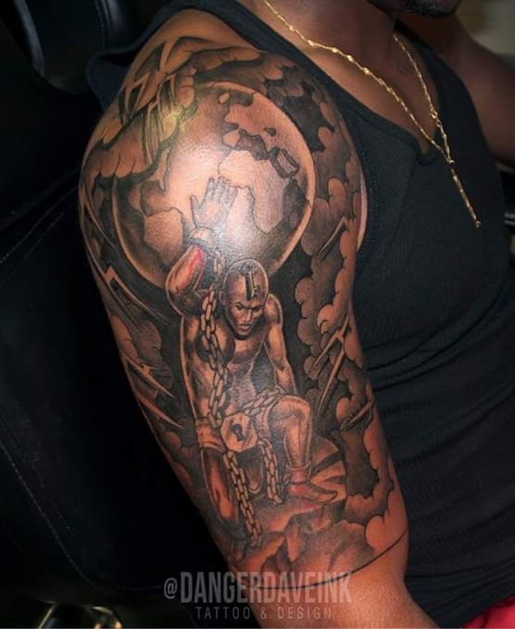 a man with a black and grey tattoo on his arm