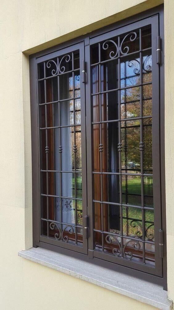 an image of a window that is in the side of a building with iron bars on it