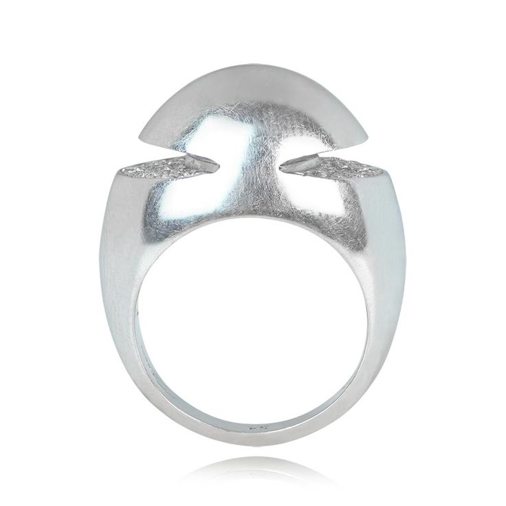 A Bulgari ring handcrafted in 18k white gold. The mounting is dome-shaped, with grooves in the sides set with half-moon designs of round brilliant cut diamonds. The inside of the ring is signed BVLGARI. This ring was made in Italy, circa 1965.
The dimensions of this ring are approximately 14.05mm x 20.31mm.
This ring can be resized.
If you have any questions about this Bulgari ring, please feel free to contact us. Modern Brilliant Cut Dome Ring For Formal Occasions, Formal Diamond Dome Ring With Polished Finish, Formal Polished Diamond Dome Ring, Diamond Dome Ring With Polished Round Cut, Modern Diamond Dome Ring For Formal Occasions, Modern Diamond Dome Ring With Open Design, Modern White Gold Dome Ring For Wedding, Modern Diamond Dome Ring With Open Shape, Formal Round Dome Ring With Pave Setting