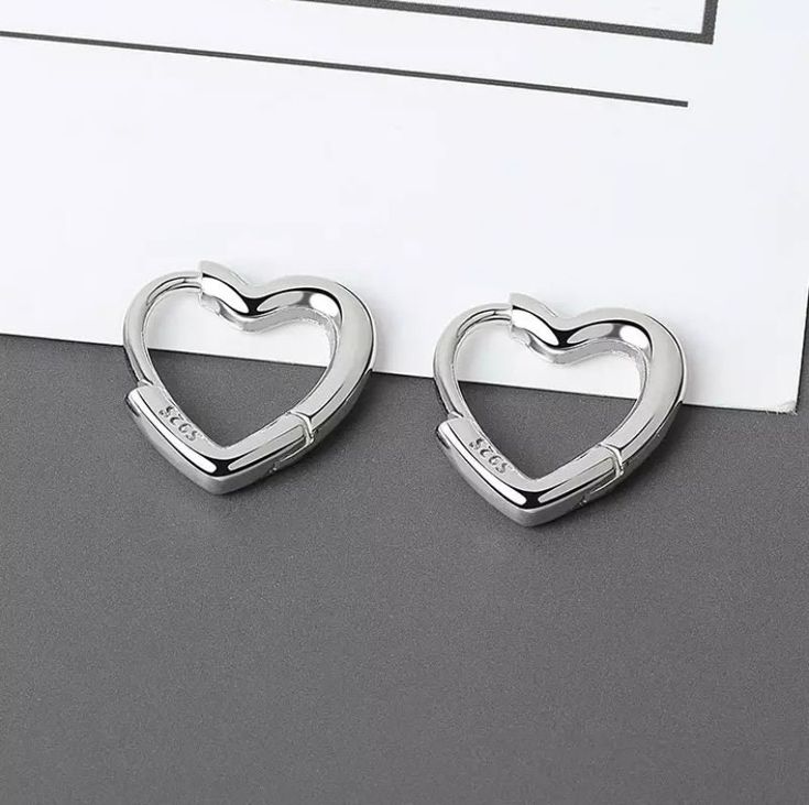 Super cute and trendy allergy free earrings. Made from 925 silver. Small Hoop Sterling Silver Heart Earrings Hypoallergenic, Trendy Small Hoop Heart Earrings, Hypoallergenic Small Hoop Heart Earrings In Sterling Silver, Trendy Silver Hypoallergenic Huggie Earrings, Trendy Sterling Silver Dangle Huggie Earrings, Trendy Hypoallergenic Silver Huggie Earrings, Modern Silver Heart Earrings For Gifts, Trendy Silver Hoop Cartilage Earrings, Trendy Sterling Silver Earrings