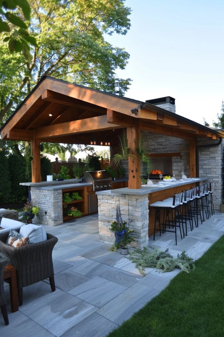 an outdoor kitchen and dining area is shown