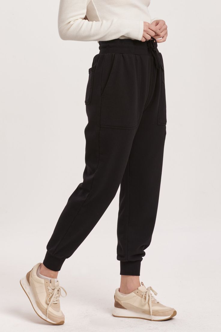 High rise ankle jogger pants with drawstring option to wear tightly or loosely for a comfy wear with utility front & back pouch pockets. Perfect for any comfy time, when you just want to cozy up! Solid color knit on relaxed fit.14" Front Rise (include waistband), 9 1/2" Leg Opening, 28" inseam (Size Small) 100% COTTON Machine wash cold, Tumble dry low Imported Black Cotton Activewear With Side Pockets, Solid Color Joggers With Side Pockets For Loungewear, Solid Color Sweatpants With Cargo Pockets For Loungewear, Black Joggers With Elastic Waistband For Jogging, Comfortable Relaxed Fit Joggers With Side Pockets, Comfortable Joggers With Side Pockets In Relaxed Fit, Comfortable Black Bottoms With Pockets, Comfortable Black Pants With Pockets, Sporty Black Bottoms With Elastic Cuffs