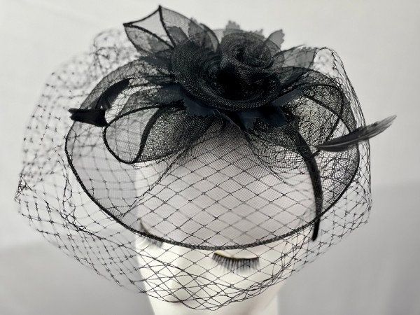 Elevate your special occasion wear with this exquisite fascinator hat, a statement piece guaranteed to captivate and complete your ensemble. Featuring a intricate design and a classic veil, this hat exudes sophistication and charm, positioning itself as the quintessential accessory for Derby events, church gatherings, weddings, and any place where fashion takes center stage. With its delicate craftsmanship and attention to detail, it not only completes an outfit but enhances the wearer's allure Elegant Evening Cloche Headpiece, Elegant Cloche Headpiece For Party, Royal Ascot Evening Fascinator With Structured Crown, Elegant Party Fascinator, Black Wedding Fascinator For Spring, Elegant Formal Cloche Headpiece, Elegant Cloche Headpiece For Formal Occasions, Elegant Mini Party Hats With Pinched Crown, Evening Hat Fascinator For Royal Ascot