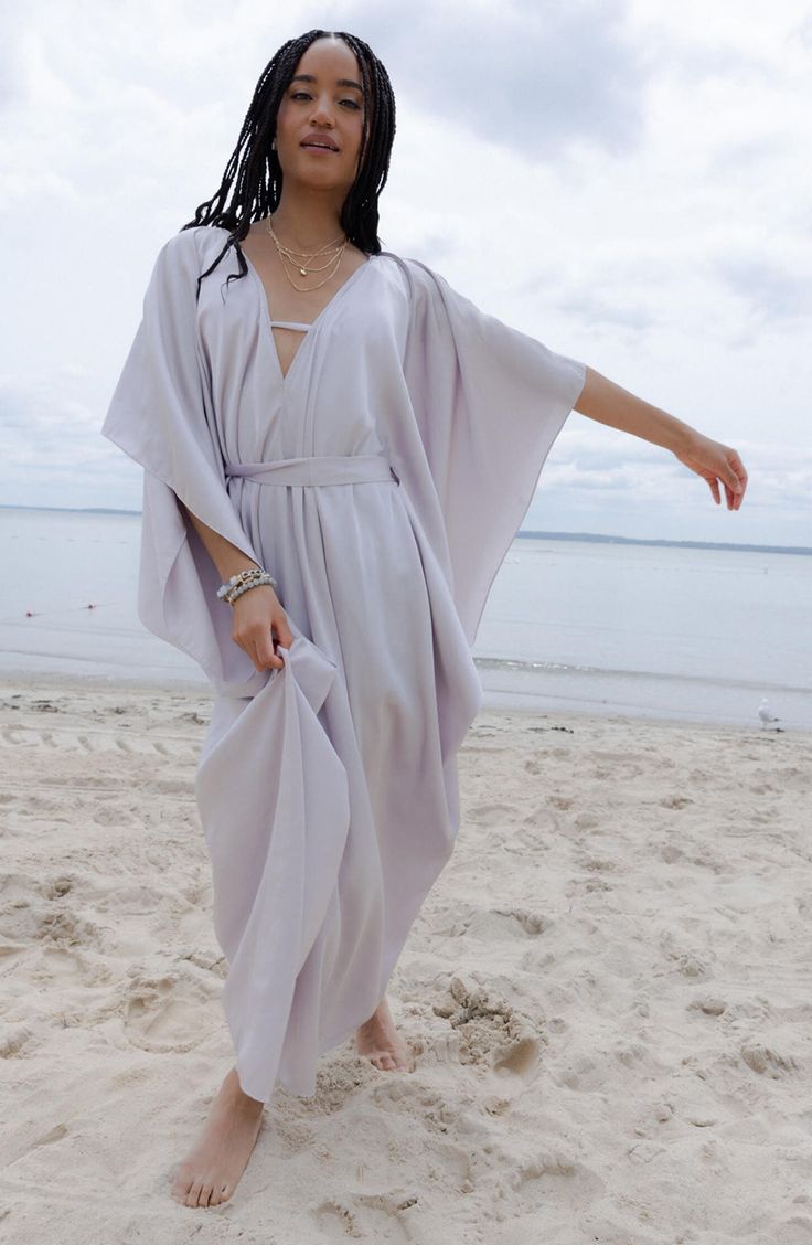 Perfect for poolside hangs or kicking it in the sand, this tie-front kaftan is the perfect accessory to add to your sun-loving wardrobe. V-neck
 Short sleeves 100% polyester satin Hand wash, line dry
 Imported Model stats: 5'10", 32" bust, 25" waist, 36" hip. Model is wearing size One Size. Bohemian V-neck Tie Waist Cover-up, V-neck Beach Dress With Tie Waist For Vacation, V-neck Kaftan For Beach Vacation, V-neck Tie Waist Beach Cover-up, V-neck Summer Kaftan For Vacation, V-neck Kaftan For Resort Season, Flowy V-neck Kaftan For Day Out, Chic V-neck Festival Cover-up, Chic Wrap Beach Cover-up