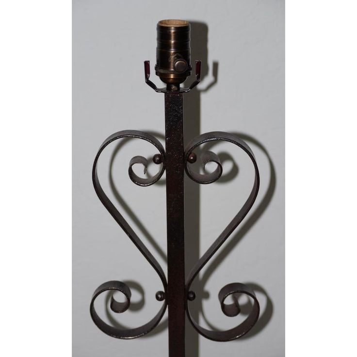 a metal candle holder with a heart shaped design on the front and back of it