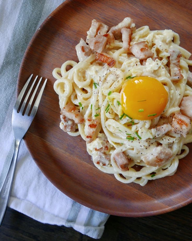 a plate with pasta and an egg on top