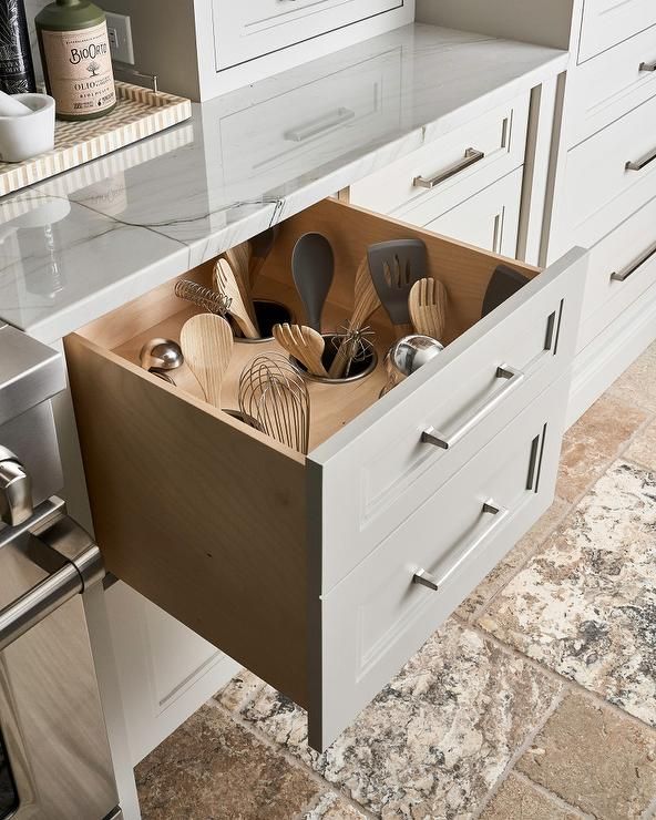 an open drawer with utensils in it