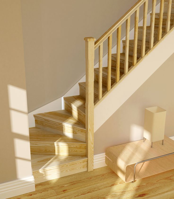 an empty room with wooden stairs and hard wood flooring