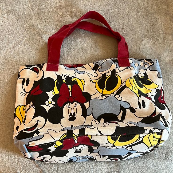 Disney Minnie Mouse Canvas Tote Bag White Minnie Mouse Bag For Daily Use, Red Minnie Mouse School Bag, Disney Minnie Mouse White Bag, White Disney Bags For Everyday Use, Cute Minnie Mouse Bags For Everyday Use, Cute Minnie Mouse Bags For Disney Trips, Disney School Bag In Red, Minnie Mouse Multicolor Travel Bags, Disney White Bags For Disney Trips