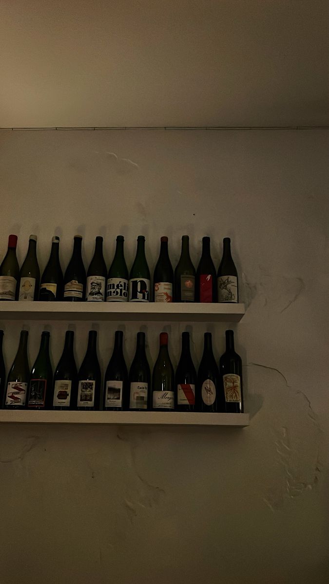 there are many bottles on the shelves in this room