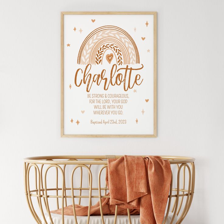 a baby crib with an orange blanket on it and a poster above the crib