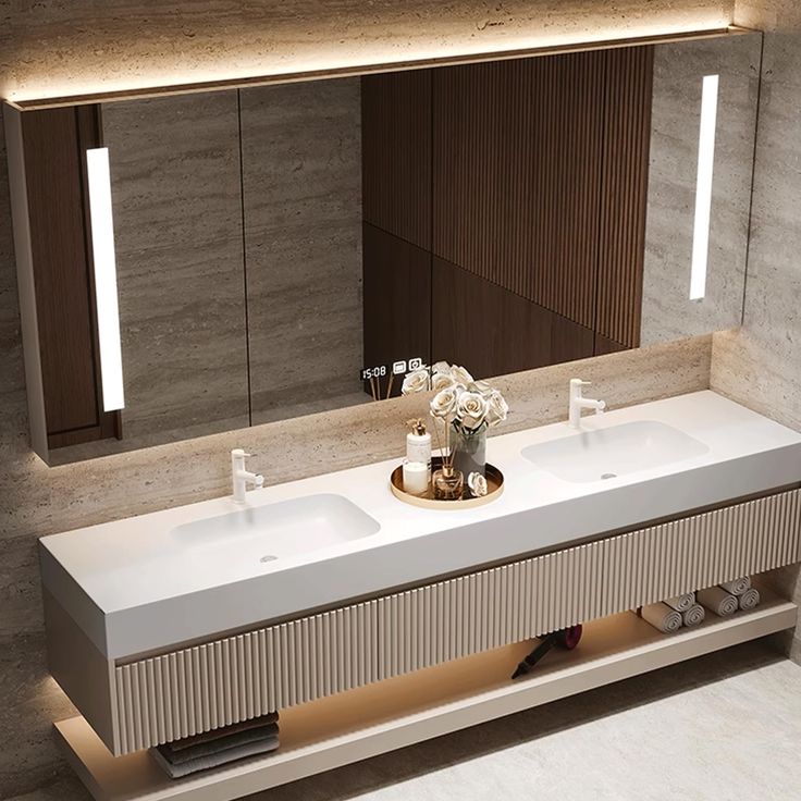 a bathroom with two sinks and a large mirror above the sink is illuminated by lights