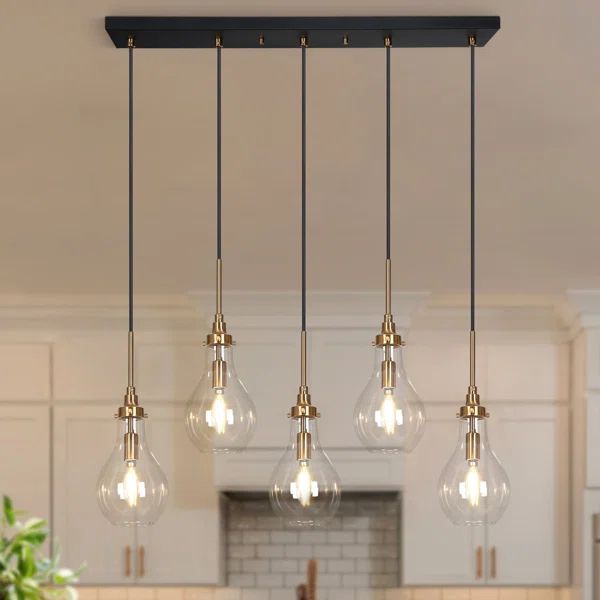 an image of a kitchen light fixture with five bulbs hanging from it's ceiling