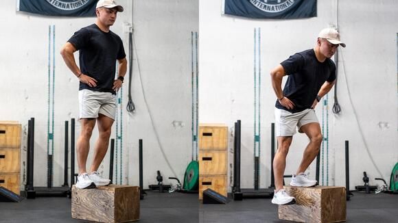 a man standing on top of a wooden block