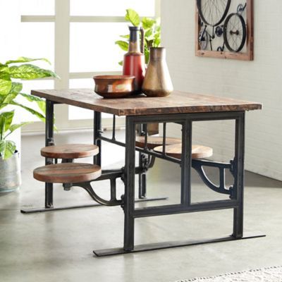 a wooden table with two stools in front of it next to a potted plant