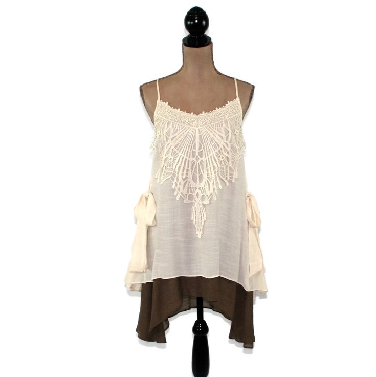 This layered dress features spaghetti straps crossed at the back and a romantic boho, mori vibe. The lace applique on the bodice and side ties also add a 20's style flapper feel to this unique loose fitting chemise. I love the creamy beige and brown combo and the high low hemline. Also available in Blue/Gray here: https://www.etsy.com/listing/656680524/romantic-clothes-layered-dress-boho-mini?ref=shop_home_active_7 Each piece in our HEART ALTERED collection has been embellished with our signatur Bohemian Spaghetti Strap Dress With Crochet Trim, Bohemian Dress With Crochet Trim And Spaghetti Straps, Bohemian Dresses With Straps, Bohemian Dress With Lace Patchwork And Spaghetti Straps, Bohemian Spaghetti-strap Dress With Lace Patchwork, Bohemian Dress With Adjustable Straps For Brunch, Bohemian Sleeveless Dress For Layering, Bohemian Lace Camisole For Spring, Spring Bohemian Lace Camisole