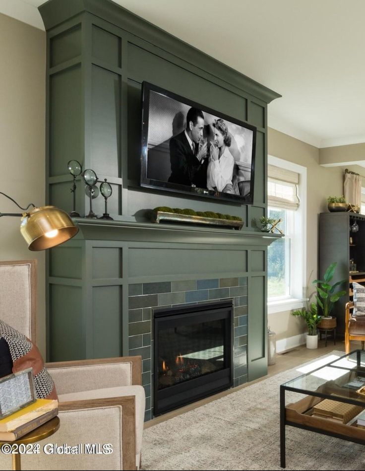 a flat screen tv mounted above a fireplace in a living room