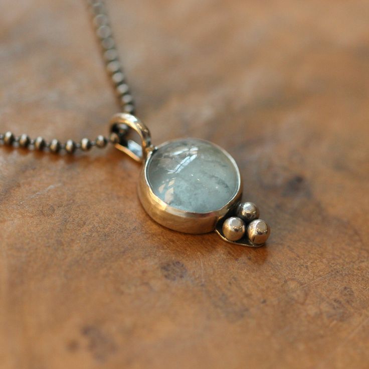 We call this the Sweetheart Pendant. Here a timeless and beautiful Aquamarine pendant - the design seems classic - might be made by a master silversmith in the seventies or maybe it came from the Mediterranean, given the high-quality semi-precious stone. A soft blue pendant you will always turn to! At Linda Blackbourn Jewelry we feel that the stones are the stars of the show when it comes to jewelry. Small and balanced embellishments to enhance the natural beauty of the semi-precious stones ... Sterling Silver Oval Pendant, Sterling Silver Jewelry With Oval Pendant, Sterling Silver Oval Pendant With Clasp, Timeless Handmade Pendant Necklace, Handmade Timeless Pendant Necklace, Timeless Silver Oval Pendant Jewelry, Timeless Silver Heart Pendant Jewelry, Timeless Sterling Silver Birthstone Necklace, Anniversary Necklace With Sterling Silver Clasp And Round Pendant