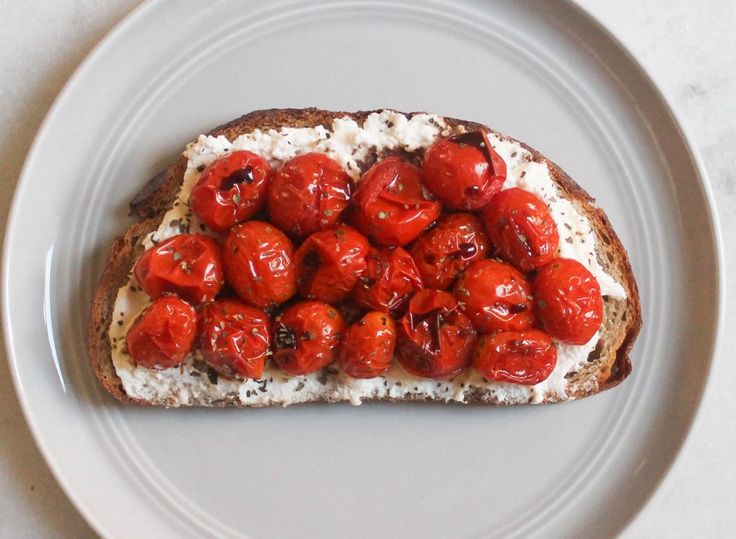 a piece of bread with tomatoes on it