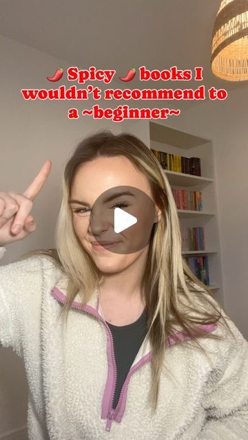 a woman in a white jacket pointing to the camera with an ad on her face that says spicy books would't recommend to a beginner