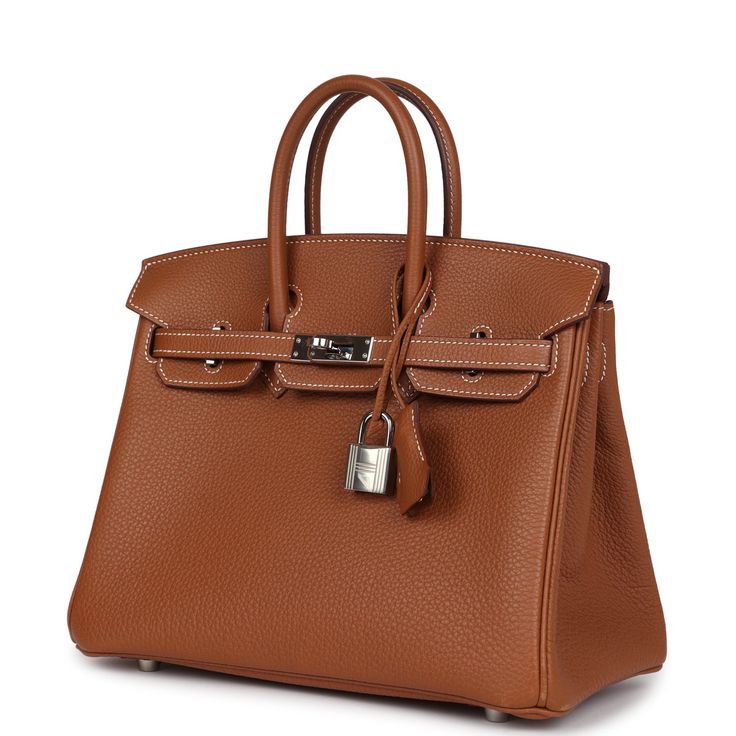 This Birkin is in Gold togo leather with palladium hardware and features contrast stitching, front flap, two straps with center toggle closure, a clochette with lock and two keys and double rolled handles.The interior is lined with Gold chevre and has one zip pocket with an Hermes engraved zipper pull and an open pocket on the opposite side.Collection: UOrigin: FranceCondition: Pre-owned; Excellent - This bag retains it shape. There's no plastic on the hardware, resulting in visible scratching to the hardware and more moderate scratching to the hardware feet. The exterior leather shows signs of wear around the corners and a small scuff to the back exterior bag and one tiny mark to front of bag. The interior leather shows signs of wear to the leather with press markings and scuffing to the Business Bags With Lock In Calf Leather, Brown Togo Leather Business Bags, Formal Brown Togo Leather Bag, Brown Togo Leather Travel Bag, Designer Brown Togo Leather Bags, Timeless Brown Togo Leather Bag, Timeless Togo Leather Bag With Lock, Luxury Everyday Bag In Togo Leather With Turn-lock Closure, Classic Togo Leather Bag With Silver-tone Hardware