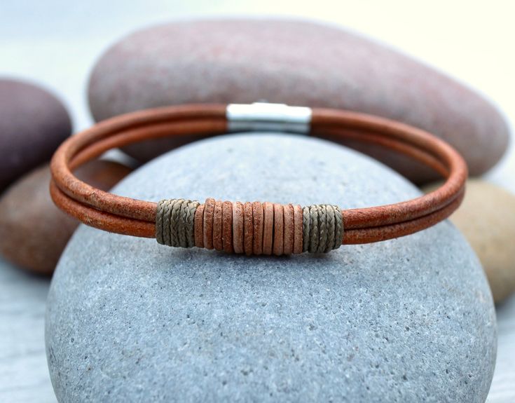 --------- PLEASE DON'T FORGET TO CHECK THE SIZE GUIDE ---------- This listing is for a unique beaded leather bracelet. Custom handmade from 2x lengths of 3mm Rustic Natural leather The bracelet is completed with matching leather and micro-paracord wrapped detailing and secured with a stainless steel magnetic twist clasp. A great looking bracelet that would look amazing on any wrist When ordering, please make your selection of bracelet size from the drop down menu. ---Sizing--- To find your bracelet size, follow these steps: STEP 1: Measure your wrist with a flexible tape, strip of paper or length of cord, just below the wrist bone, where you would normally wear the bracelet. The tape should be firm around the wrist but not too tight. STEP 2: If you are using a strip of paper or cord, mark Rustic Bracelet, Leather Anniversary Gift, Beaded Leather Bracelet, Leather Anniversary, Handmade Leather Bracelets, Brown Leather Bracelet, Gorgeous Bracelet, Braided Bracelets, Leather Items