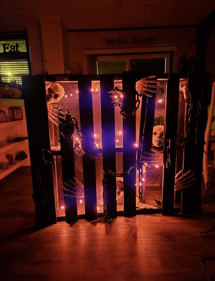 an image of halloween decorations on display in the dark with purple light coming from behind