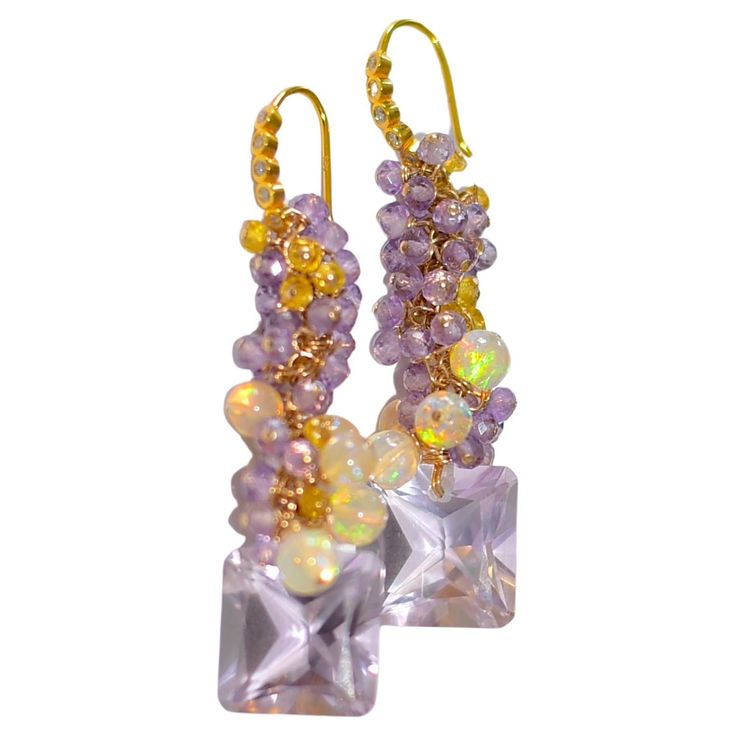 Unique moving earrings where I used Natural Pink Amethyst stone, Amethyst stones, Opal, and Yellow Sapphire to adorn the beauty of these earrings just for your ears! Total length: 1.8inches Natural Pink Amethyst: 14mmx14mm Natural Amethyst beads, 3mm Opal, 2.9mm Sapphire 8mmx14.5mm 14k Solid Yellow Gold Diamond Bezel Set Earwires (Extraordinary 14K solid yellow gold ear wires with sparkly diamond bezels in the front. The diamond's average G color, SI1-2 clarity, 0.15 carat weight.) Amethyst Stones, Amethyst Beads, Pink Amethyst, Opal Earrings, Bezel Diamond, Yellow Sapphire, Amethyst Stone, Solid Yellow, Purple Amethyst