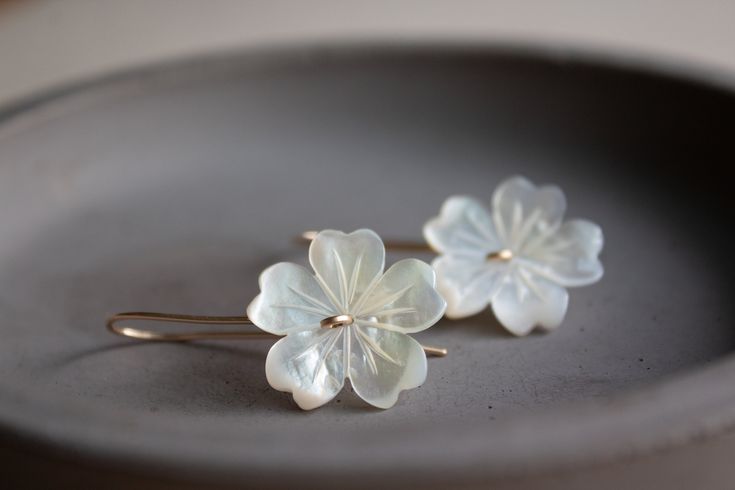 "Beautiful and elegant flower earrings. Perfect bridal pair of earrings. These earrings feature hand-carved white mother of pearl shell, creating sweet flowers. These flowers then made into small threader earrings in your choice of metal: sterling silver, 14k gold-filled, or rose gold filled. These pair of earrings are a perfect everyday piece of jewelry that is also perfect for any special occasion. Earrings measure at 1 1/2\" long 3,5 cm Flowers are 20 mm long and wide. PACKAGING -Your purchas Delicate Handmade Flower Drop Earrings, Elegant Earrings With Handmade Flowers As Gift, Anniversary Pearl White Flower Earrings For Pierced Ears, Elegant Mother Of Pearl Flower Earrings For Weddings, Handmade White Sterling Silver Flower Earrings, Delicate White Pearl Pierced Earrings, Elegant Flower Pendant Earrings As Gift, Flower-shaped Mother Of Pearl Earrings For Wedding, Dainty White Pierced Flower Earrings