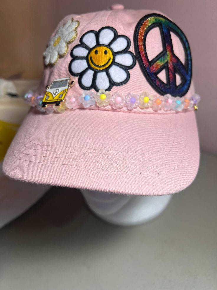 Pale pink Baseball Hat  Patches and Volkswagen hat pin 🌻 Groovy Retro Hippie Trucker Hat 🌻 Embrace the 70's hippie vibes with our Groovy Retro Hippie Trucker Hat! This 5-panel hat is a perfect blend of vintage style and modern design, making it an ideal summer gift idea for anyone who loves the groovy era. ✨ Features: High-quality bead design that adds a unique and artistic touch. Custom patches featuring rainbow sunflowers and peace signs for that authentic hippie feel. Comfortable and breath Trendy Pink Brimmed Hat, Cute Adjustable Hats For Festivals, Pink Visor Hats One Size, Cute Adjustable Festival Hats, Pink Visor Hat One Size Fits Most, Trendy Pink Brimmed Mini Hats, Pink Visor Hat, Pink Mini Hat For Festivals, Cute Adjustable Visor Hat