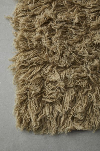 a close up of a shaggy rug on the floor with no one around it or someone else