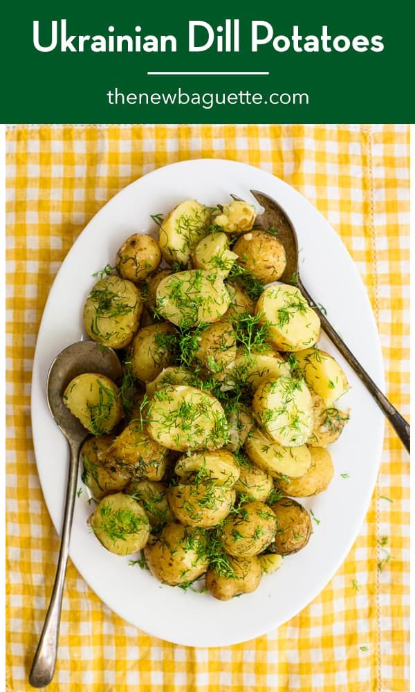 a white plate topped with potatoes covered in dill