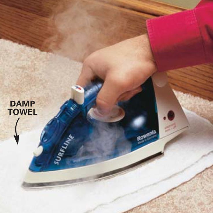 a person using a steam mop on a carpet