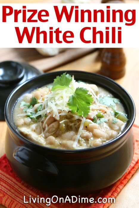 a black bowl filled with white chili and garnished with cilantro