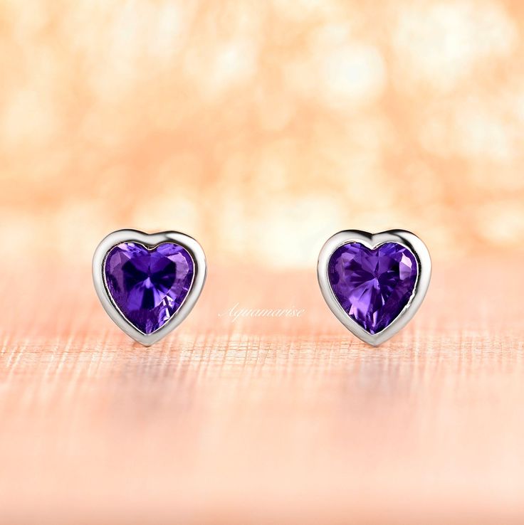 Gorgeous heart tanzanite earrings are made of 925 solid sterling silver, making a simple but elegant piece. These earrings are perfect to wear as everyday jewelry or for any occasion. Elegant and minimalist. ►Gemstone information: Center Stone: Tanzanite Gemstone creation: Simulated Shape: Heart Measurements: 6x6 mm Total carat Weight: 1.9-2.3 ct. (approx.) Hardness: 8-8.5 (Mohs scale) ►Matching necklace can be purchased here: https://www.etsy.com/listing/1113769901/heart-tanzanite-necklace-ster Formal Birthstone Earrings For Valentine's Day, Sterling Silver Gemstone Earrings For Valentine's Day, Sterling Silver Heart Cut Gemstone Earrings, Heart Cut Gemstone Earrings For Wedding, Wedding Heart Cut Gemstone Earrings, Silver Bezel Set Earrings For Wedding, Silver Wedding Earrings With Bezel Setting, Sterling Silver Earrings With Bezel Setting As Gift, Classic Gemstone Earrings For Valentine's Day