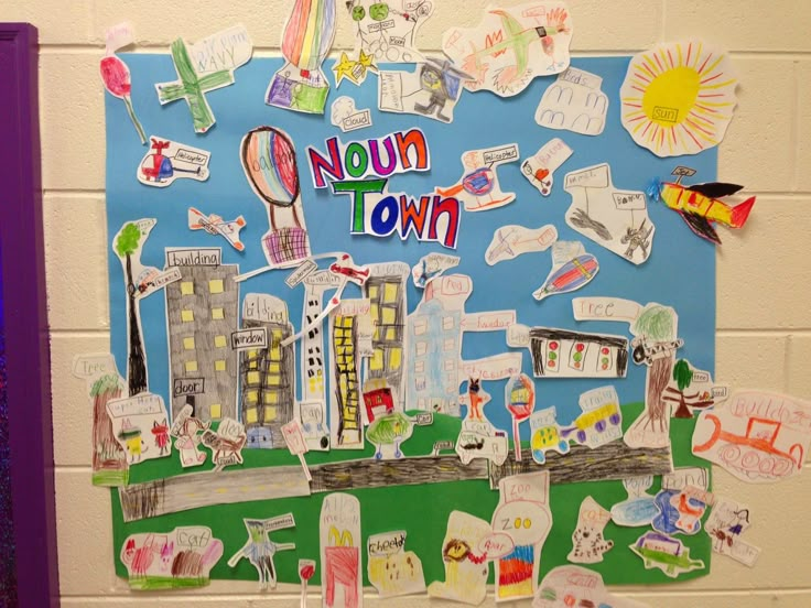 a bulletin board with the word noun town written on it and various stickers attached to it