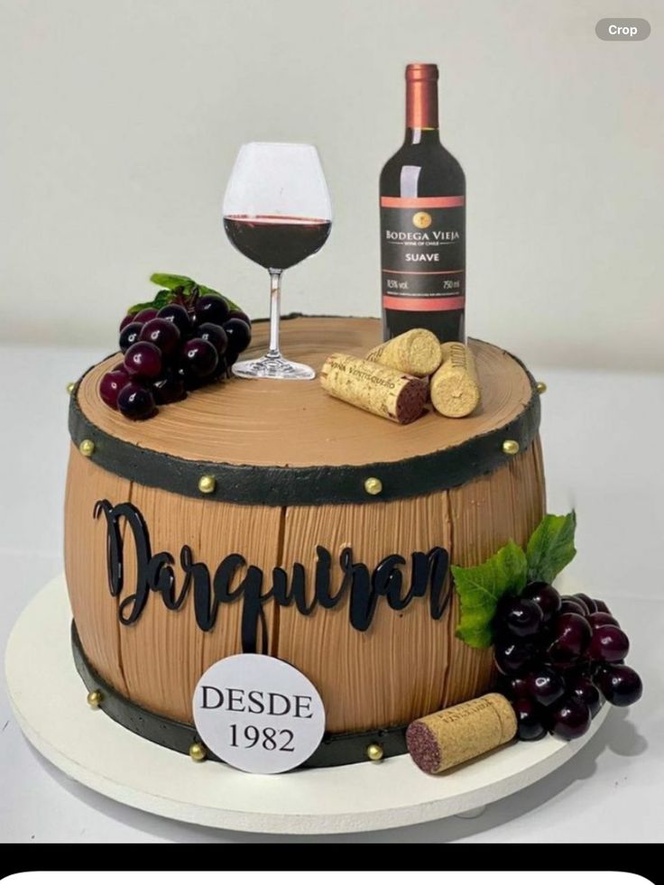 a cake with wine and grapes on it