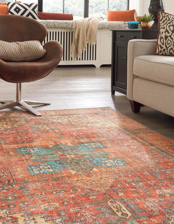 a living room with a chair, couch and rug